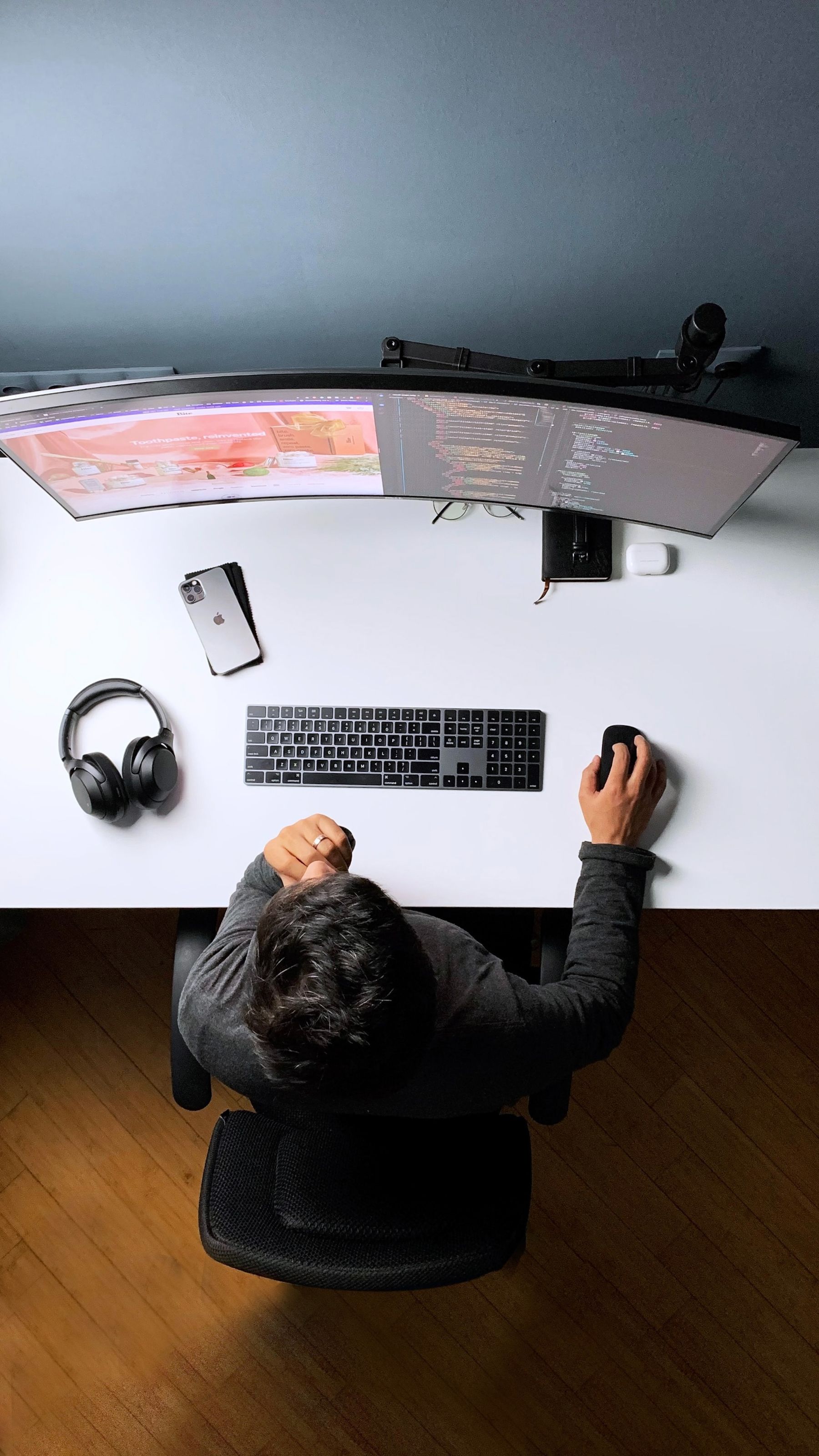 A wide multi-monitor workstation used for software development